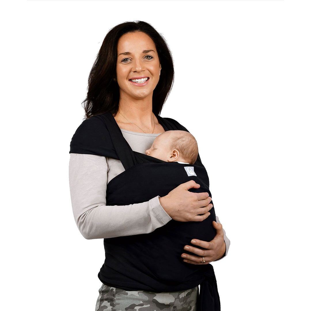 Model with a baby wearing Gaia Baby Stretchy Baby Wrap Pure Tencel™ in Ebony colour. The product won Bronze in Junior Design Awards 2022 