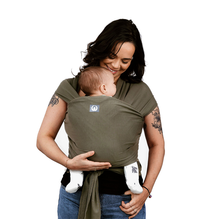 Model with a baby wearing Gaia Baby Carry Stretchy Baby Wrap Pure Tencel™ in Forest Green