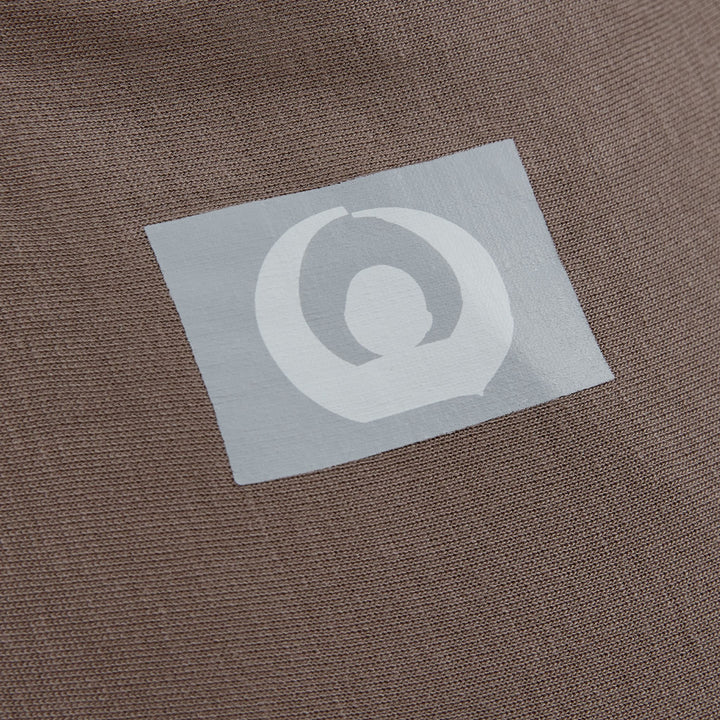 Stretchy Baby Wrap Pure Tencel™ in Nutmeg colour close up image of the logo