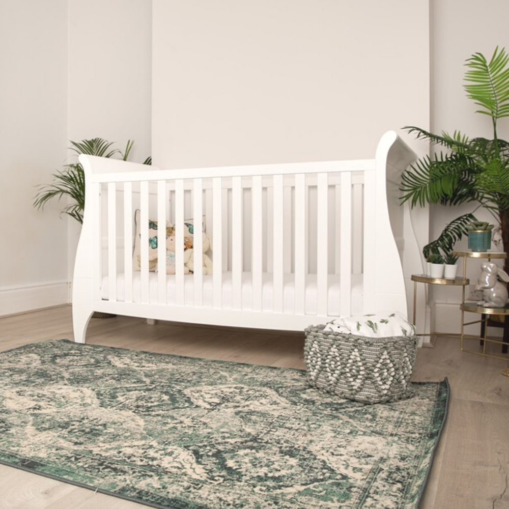Gaia Baby Leto Cot Bed lifestyle image. White cot bed in a gender neutral nursery