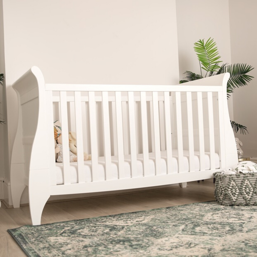 Gaia Baby Leto Cot Bed lifestyle image. White cot in a gender neutral nursery